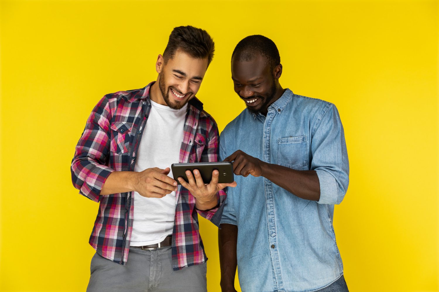 men enjoy watching videos on the tablet